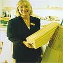 Kathy, of Property Repair Systems, holds a decorative arch piece - a Timber Resin Splice