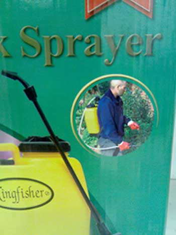 Close up view of knapsack sprayer in use